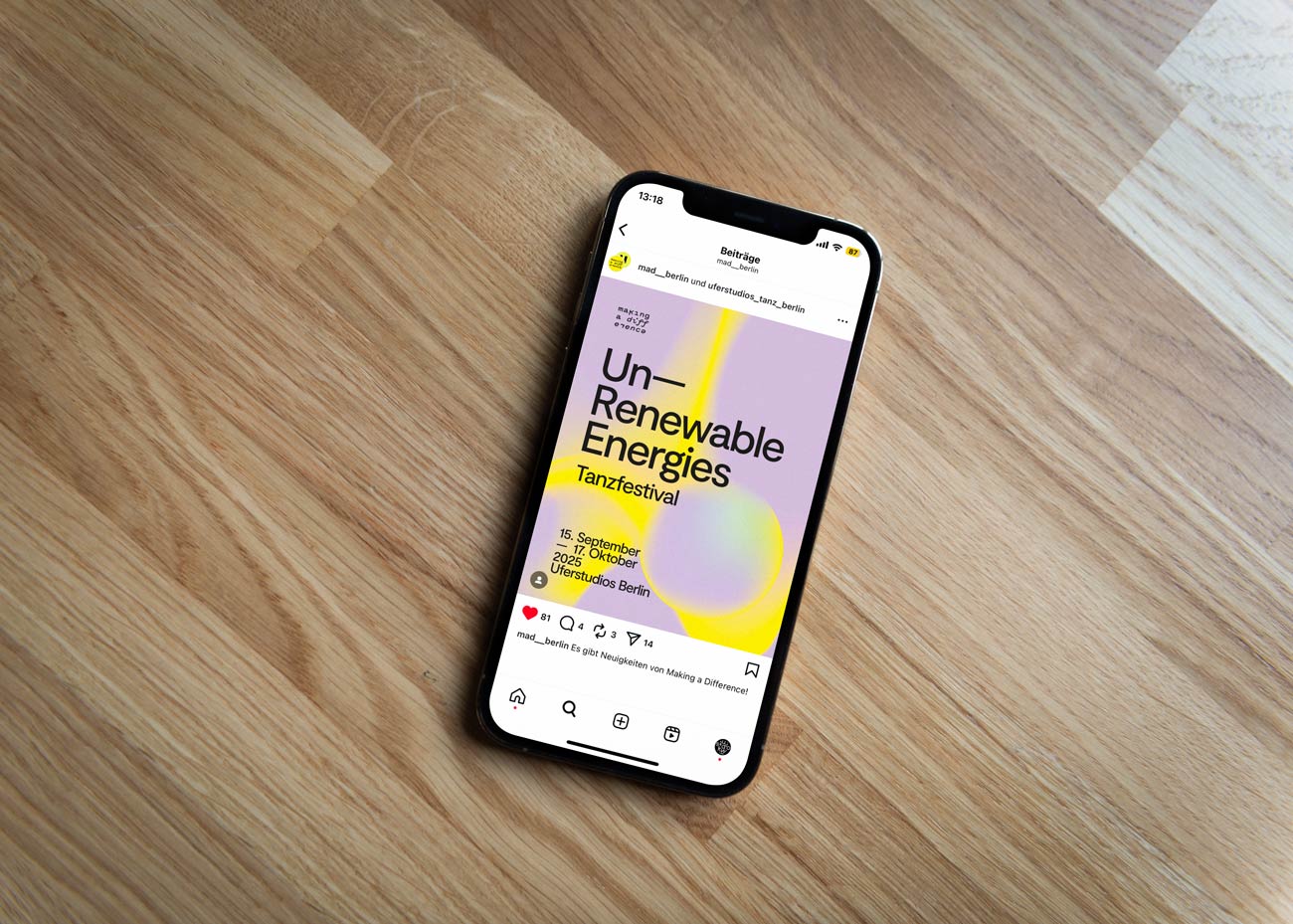 Smartphone liegt auf Holzboden, Bildschirm zeigt Instagram-Post mit Text 'Un-Renewable Energies Tanzfestival 15. September bis 17. Oktober 2022 Tanzhaus Berlin' auf lila-gelbem Hintergrund